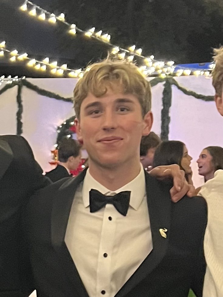 Headshot of me in a blue suit, smiling